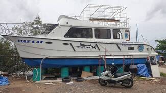 Powered Catamaran on a stand in a boat yard.Picture