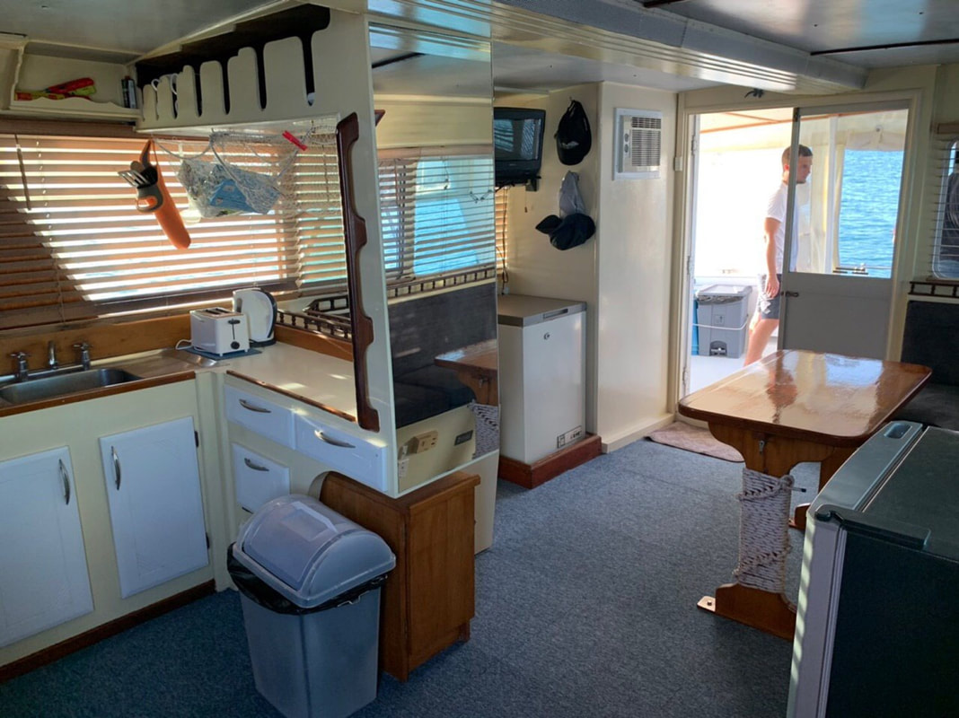 Solita has a fully air conditioned galley for cooking fresh fish for lunch or Phuket fishing over night charters Picture